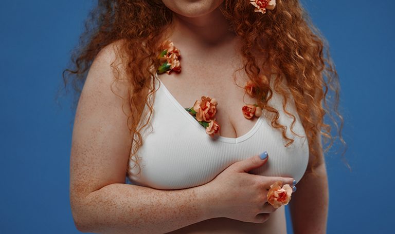 Redhead girl with freckles on a blue background